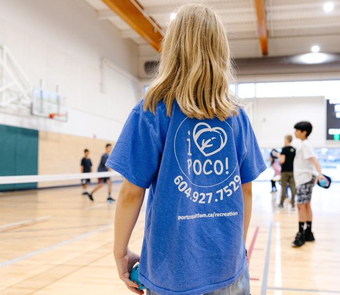 Kid in gymnasium wearing I Love PoCo Recreation shirt