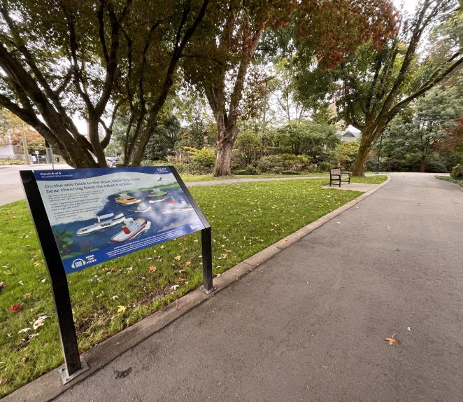 Panel along a pathway with a short story and illustration written on it