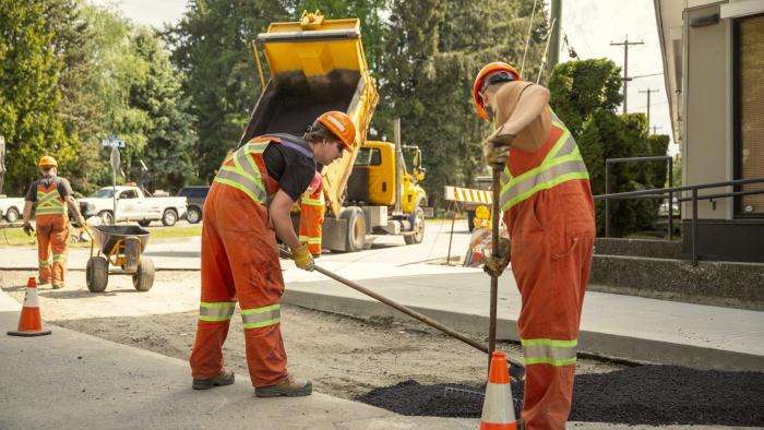 Construction workers doing road work.