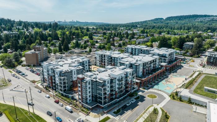 Aerial view of apartment buildings. There are multiple city blocks with buildings on them.