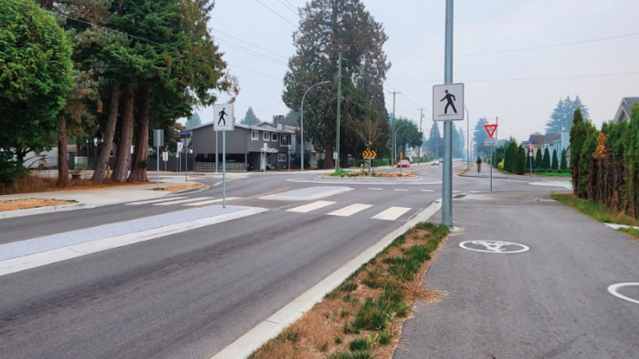 Pedestrian crossing leading to a trail path.