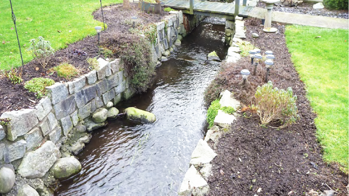 Wooden bridge crossing over a small creek.