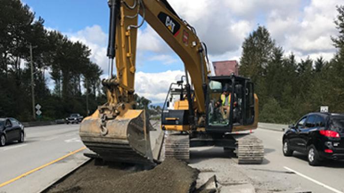 Construction machinery digging a hole.