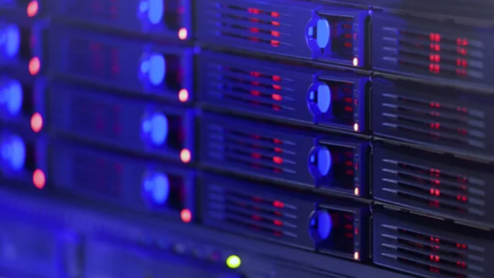 Dimly lit server blades. The server blades have an array of lights lit up.