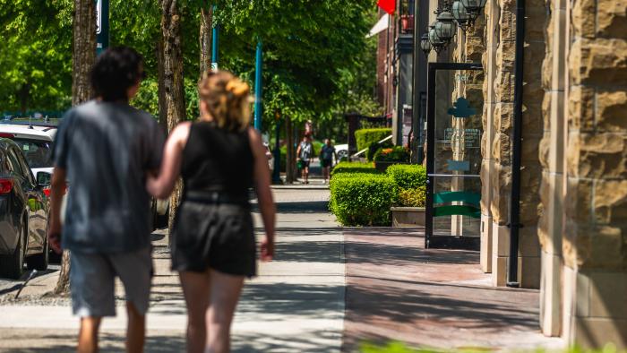 Two people walking through business area in Port Coquitlam