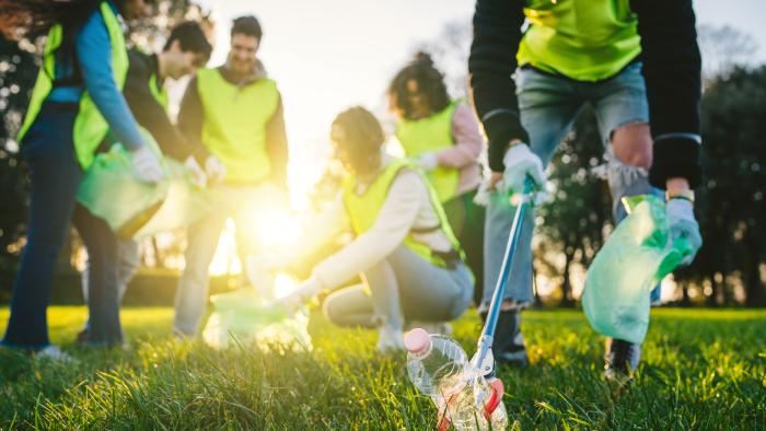 People picking litter in a park