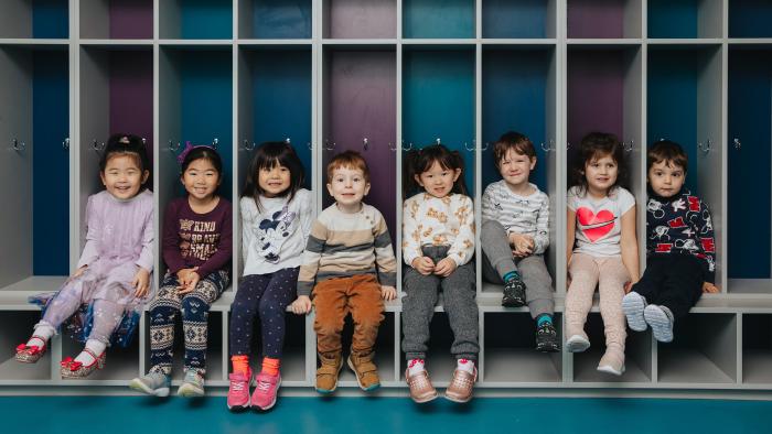 Kids sitting in cubbies at preschool