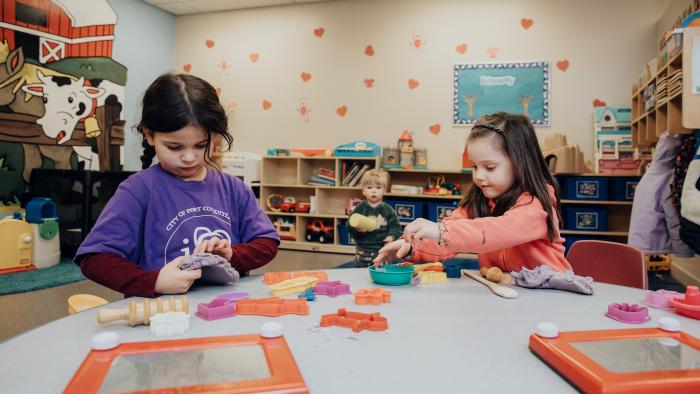 Children working on art project at a table