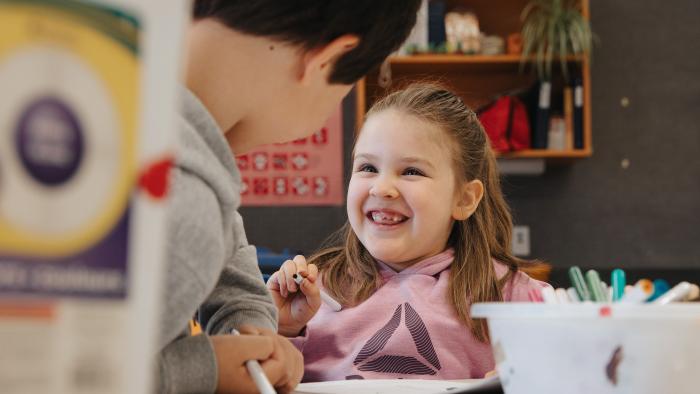 Two children colouring together