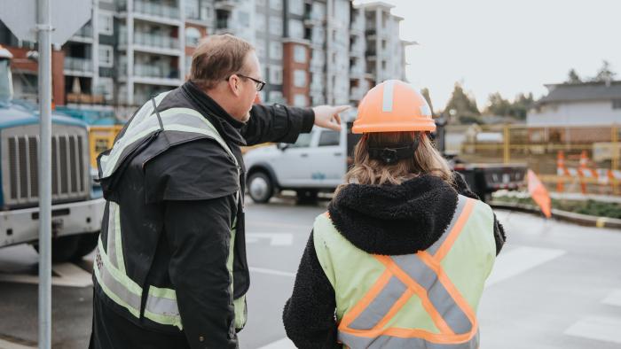 People overseeing work wearing hard hat and high vis vest