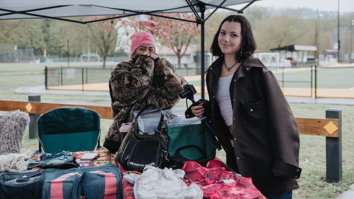 Garage sale sellers at their booth