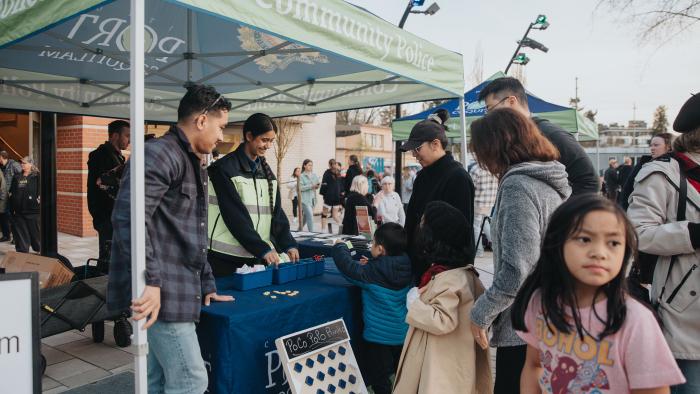 Community police volunteers at booth during community event