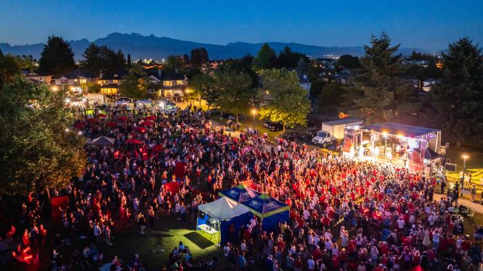 aerial view of crowd in front of stage at Canada Day celebration in the park