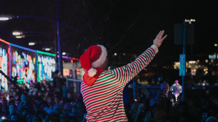 performer waving to crowd from holiday train