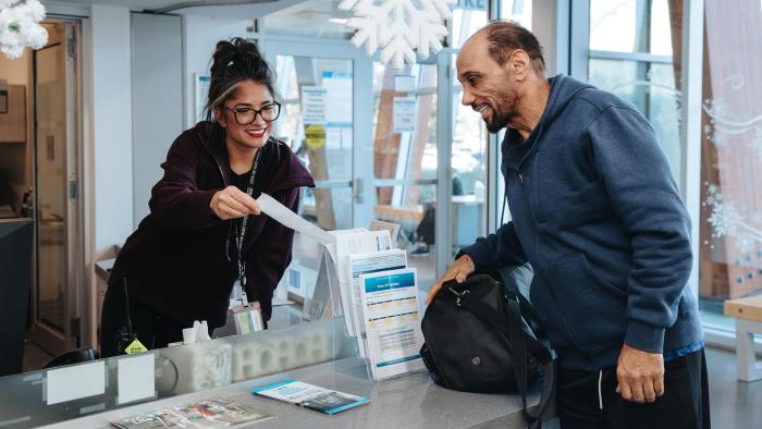 receptionist showing document to customer