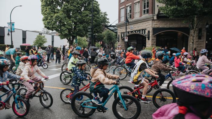 kids doing a street bicycle race downtown poco