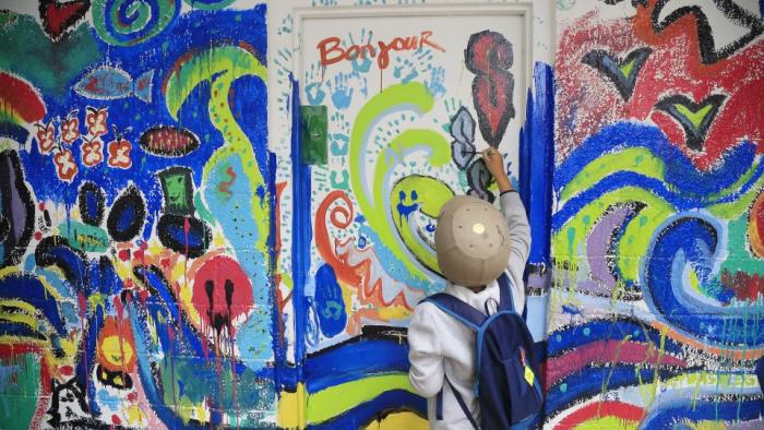 person painting bright mural