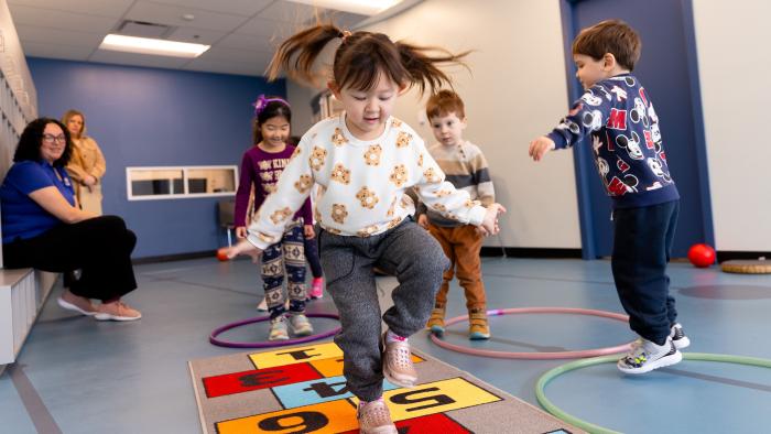 child playing hopscotch indoors
