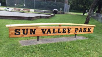 Sun Valley Park sign. The sign is wooden with dark lettering.