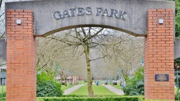 Signage for Gates Park. There is an arch with pillars made of brick and the arch made out of concrete. The lettering is on the concrete arch.
