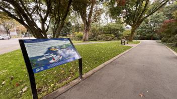 Panel along a pathway with a short story and illustration written on it
