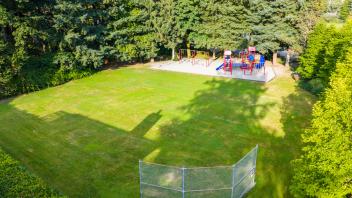 aerial view of cameron park with grass area and playground