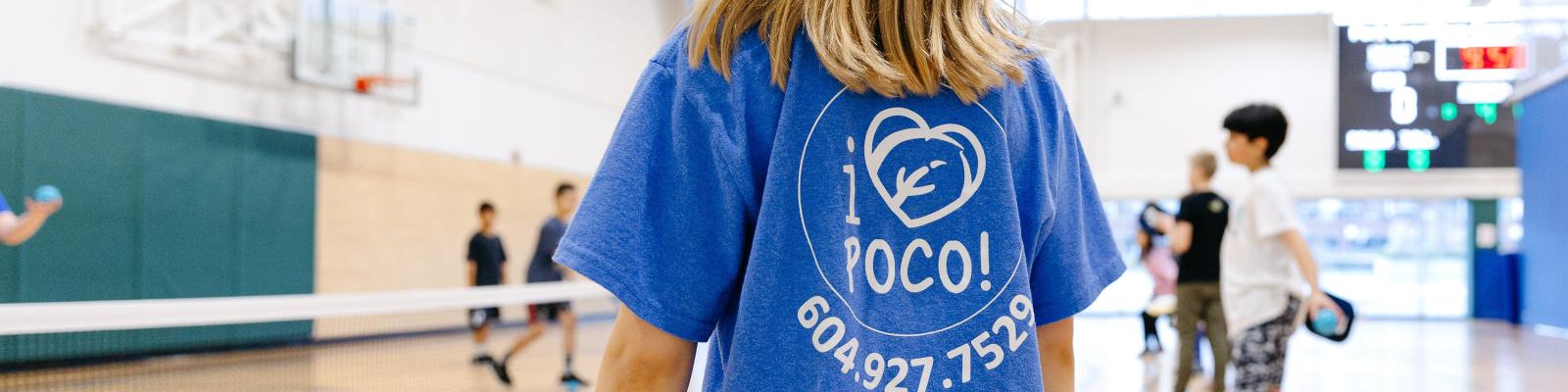 Kid in gymnasium wearing I Love PoCo Recreation shirt