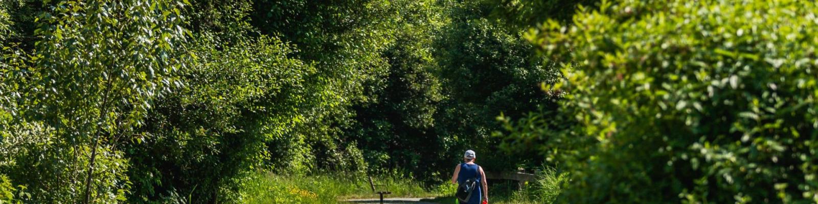Person walking along a trail at Blakeburn Lagoons Park