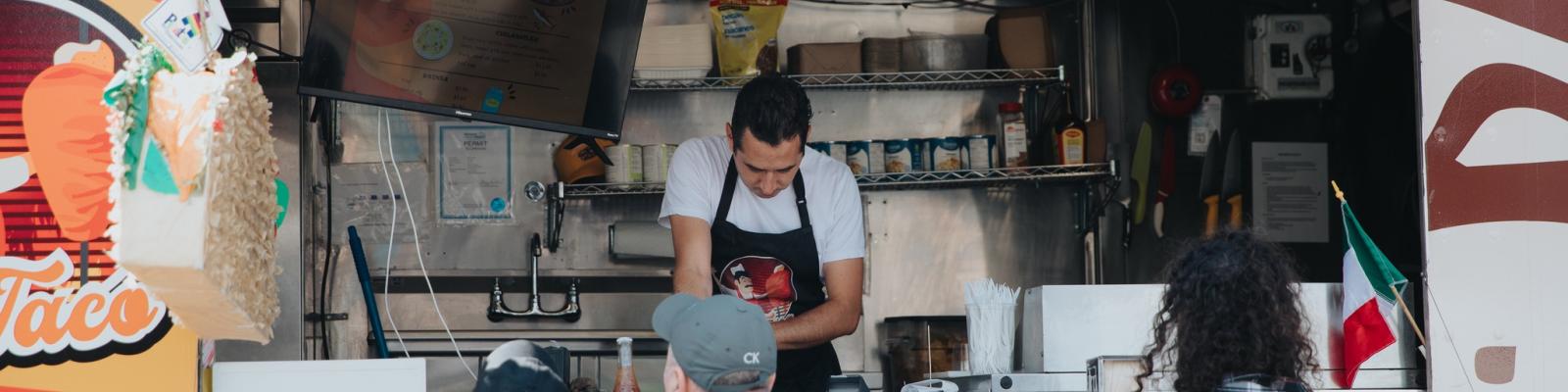 People gathered around a taco food truck