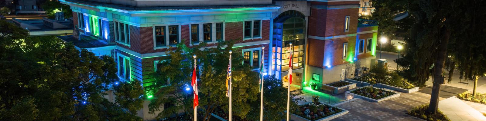 City Hall lit up with blue and green lights