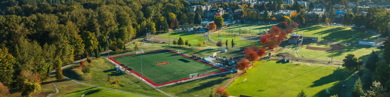 Aerial view of Gates Park showing green spaces, sports fields, mountains and trees