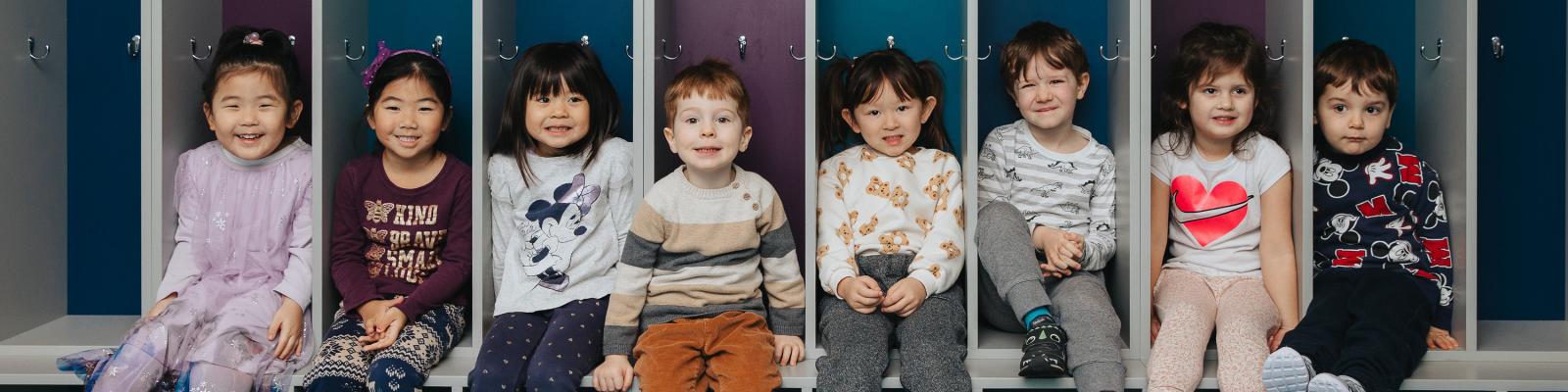 Kids sitting in cubbies at preschool