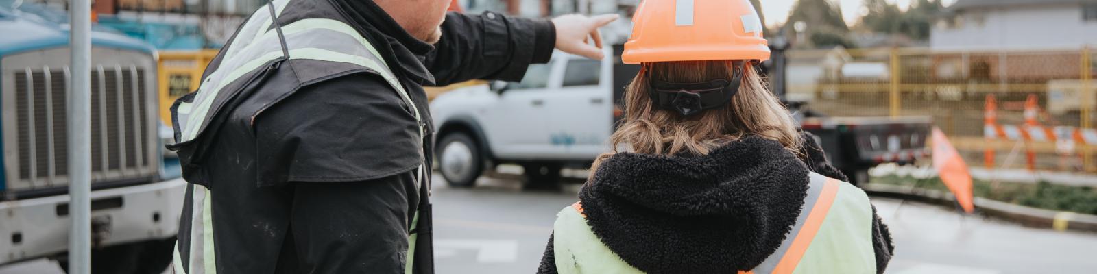 People overseeing work wearing hard hat and high vis vest
