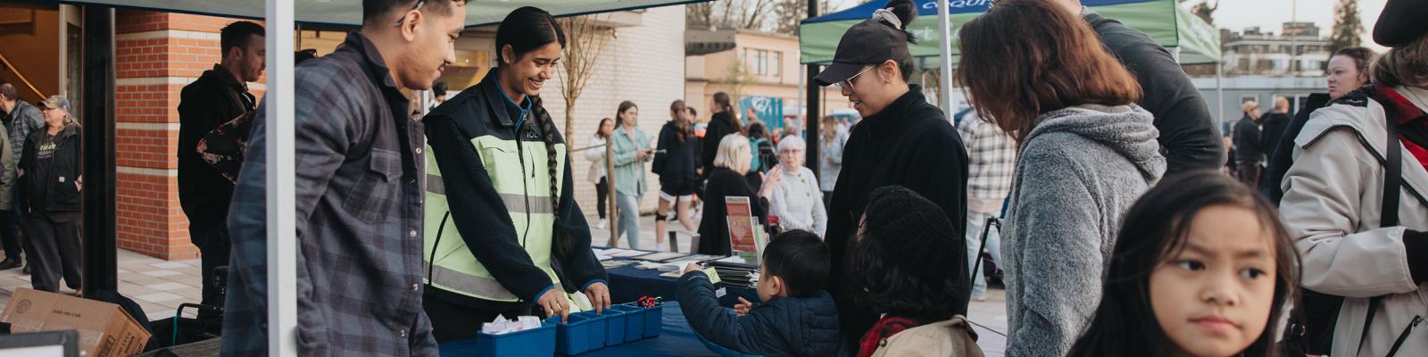 Community police volunteers at booth during community event