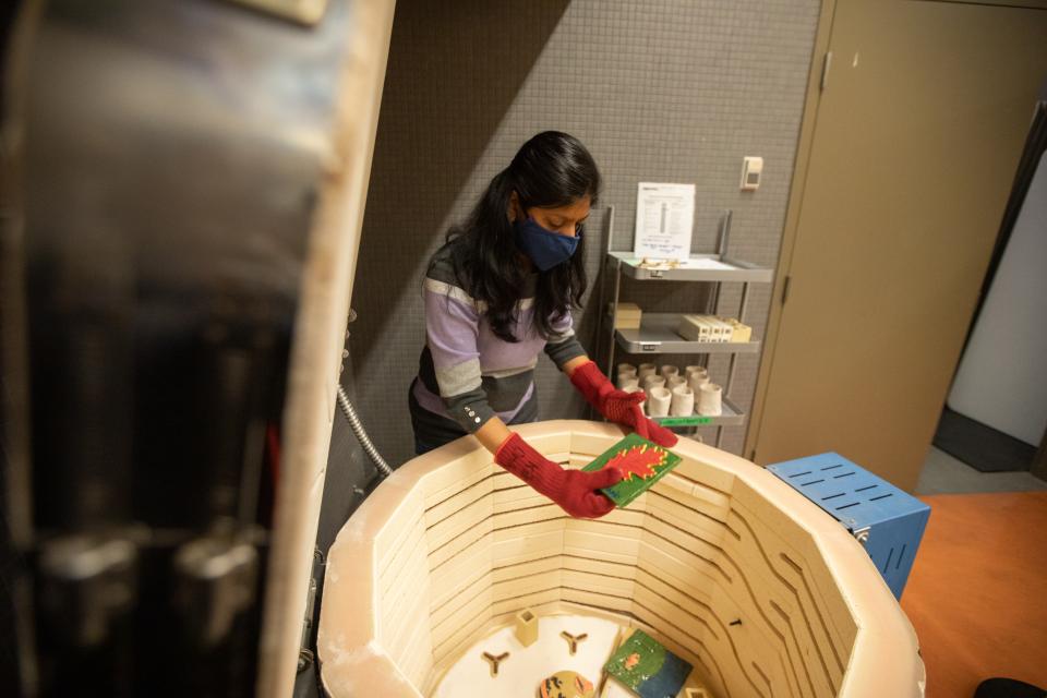 A woman working in a clay kiln