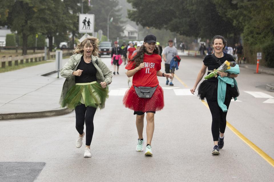 three people reaching the finish line at Terry Fox Run