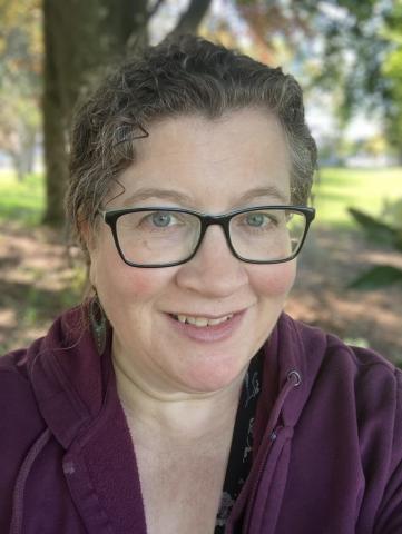 Headshot of Lisa Hoffman. There is a woman wearing glasses and smiling.