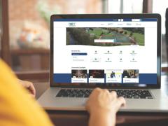 Person on laptop with Port Coquitlam website on the screen