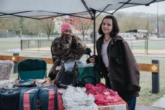 Garage sale sellers at their booth