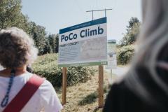 People standing in front a sign at outdoor PoCo Climb trail