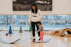 Mother and child playing in gymnasium
