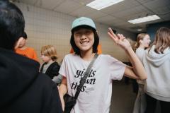 Youth at youth centre holding a peace sign in the air