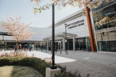 outside Port Coquitlam Community Centre with cherry blossoms in bloom