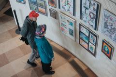 two people in Michael Wright Art Gallery, looking at artwork on display