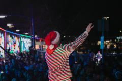 performer waving to crowd from holiday train