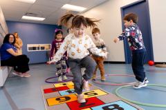 child playing hopscotch indoors