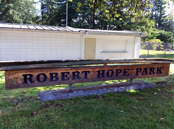 Robert Hope Park signage. The sign is wooden with dark lettering.