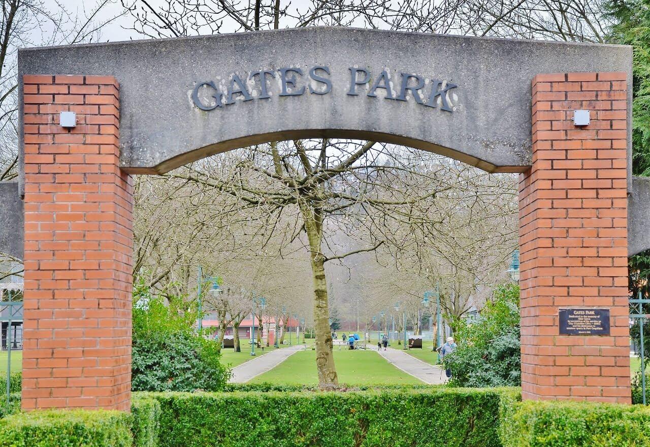 Signage for Gates Park. There is an arch with pillars made of brick and the arch made out of concrete. The lettering is on the concrete arch.