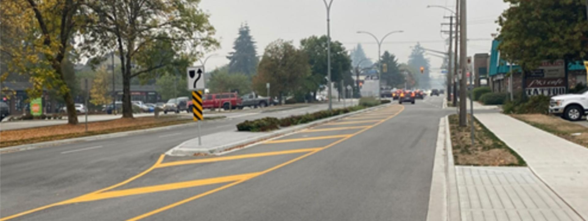 A wide boulevard with hazy sky in the background