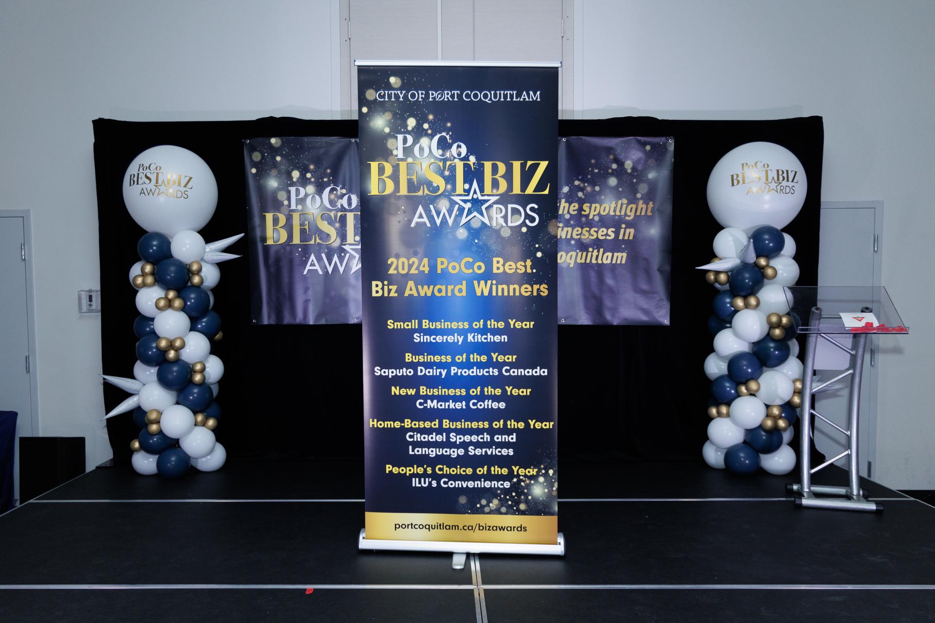 Stage for Best Biz Awards celebration with balloons and banner